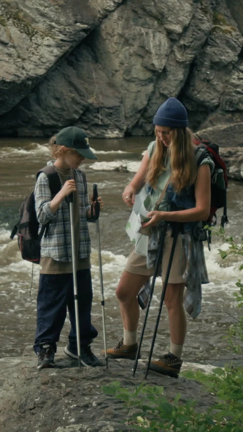 Mother and Son Looking at Map near River Video stock 315160962
