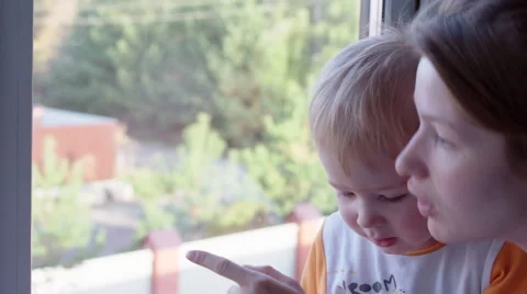 Mother and Son Looking Out the Window Curiously Stock Footage 56694981