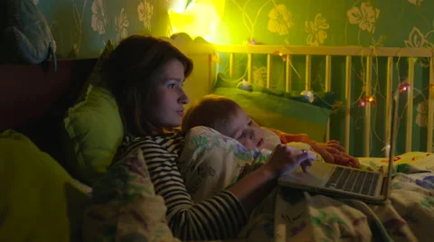 Mother and Son Lying in Bed with Laptop Stock Footage 56725967