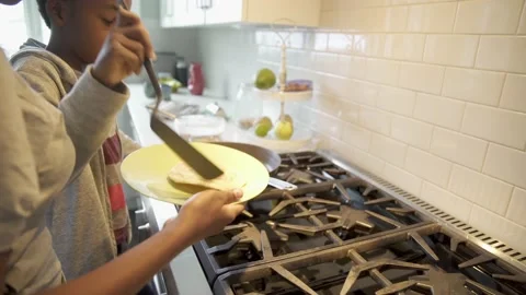 Mother and son making pancakes in kitchen Stock Footage 220171852