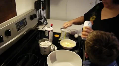 Mother and son mixing cookie ingredients Stock Footage 10724092