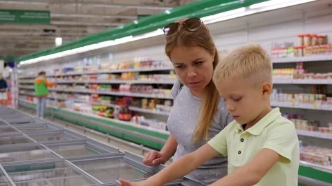 A mother and son open a large industrial refrigerator in a shopping center. Stock Footage 315380583
