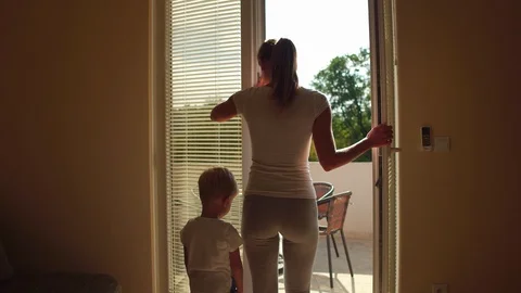 Mother and son open window and looks out the window. Stay at home and quarantine Stock Footage 127695862