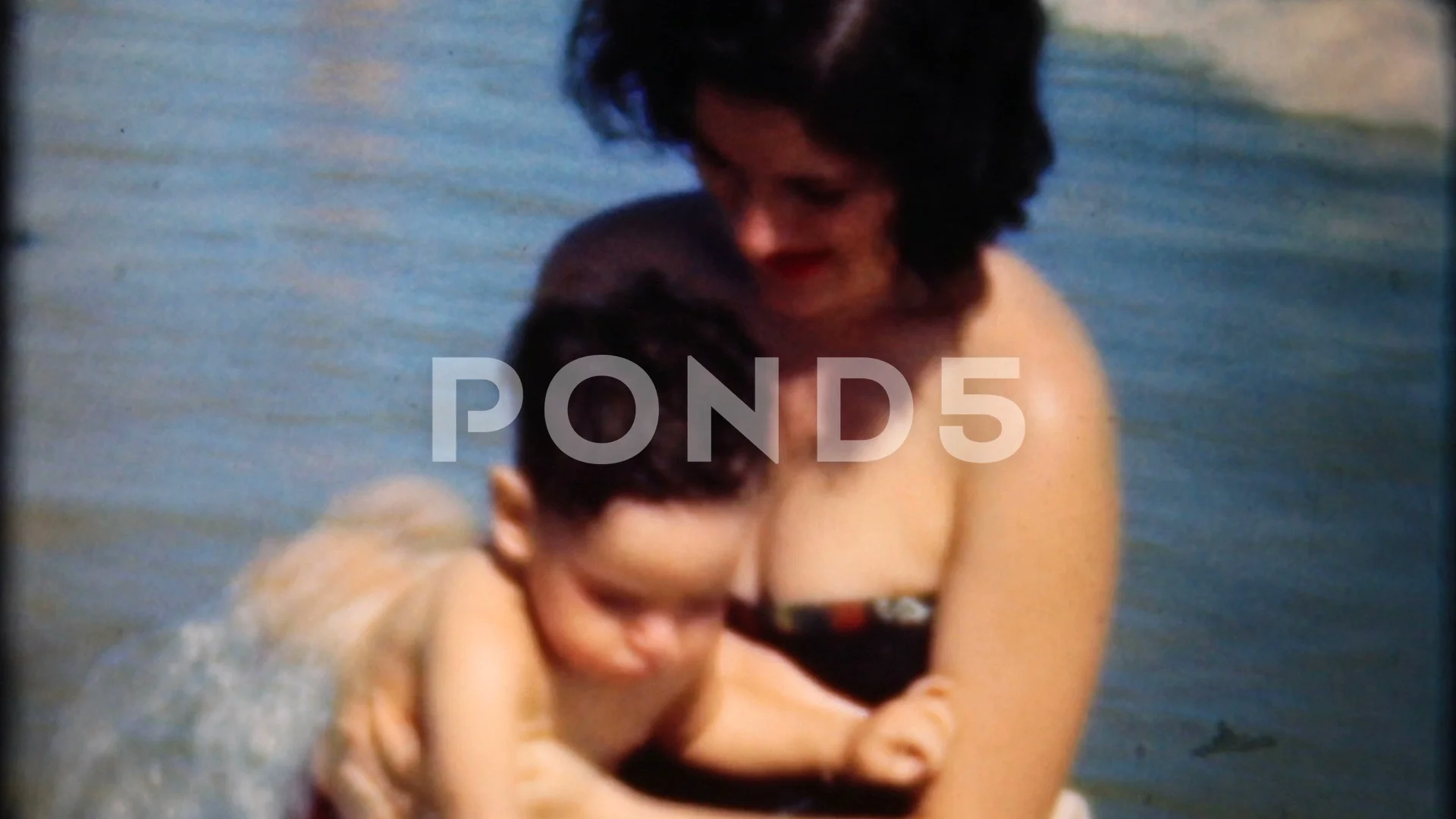 mother and son play in shallow water at ... | Stock Video | Pond5