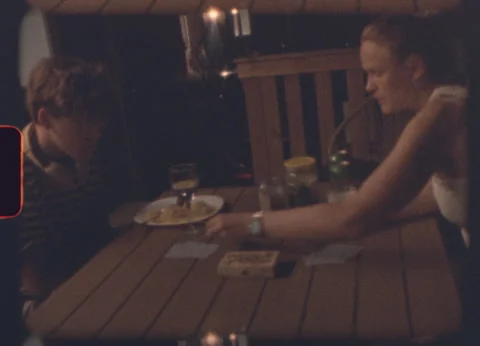 Mother and son playing cards at night on a wooden terrace Stock Footage 319828679