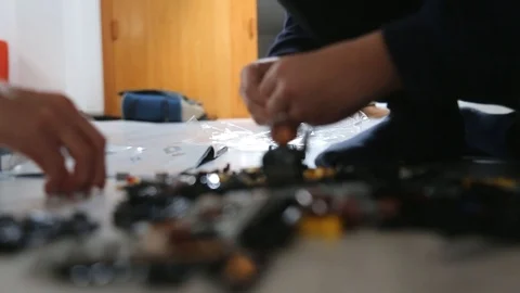 Mother and Son playing with interlocking plastic bricks toy Stock Footage 123496638