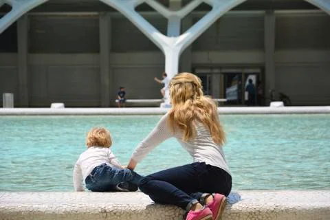 Mother and son playing in the pond Stock Photos