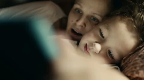 Mother and son playing on tablet PC before bed Stock Footage 40524583