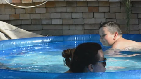Mother and son in the pool Stock Footage 26783696