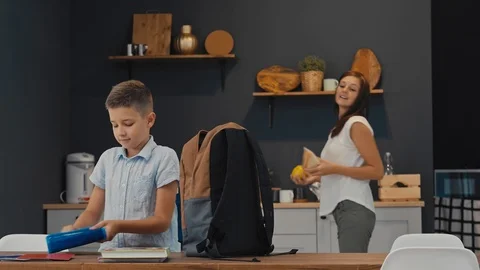 Mother and son prepare a backpack for the first school day Stock Footage 92839749