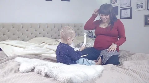 Mother and son is preparing for a new baby. FULL HD. tracking shot Stock Footage 73968870