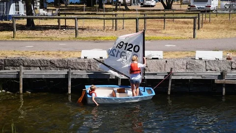 Mother and son preparing small sailboat Stock Footage 93121865