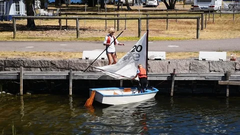 Mother and son preparing small sailboat Stock Footage 93121923