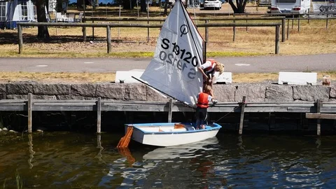 Mother and son preparing small sailboat Stock Footage 93121980