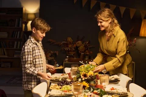 Mother and Son Setting Table for Festive Family Dinner Stock Photos