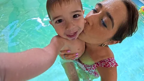 Mother and son sharing joyful moments in swimming pool Stock Footage 313300832