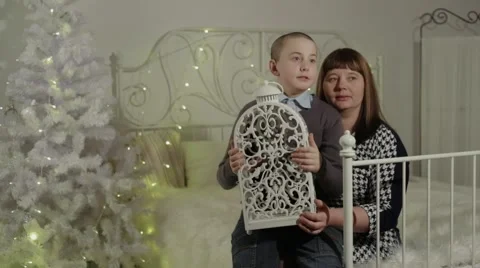 Mother and son  sitting on the bed in a New Year's interior Stock Footage 59188584