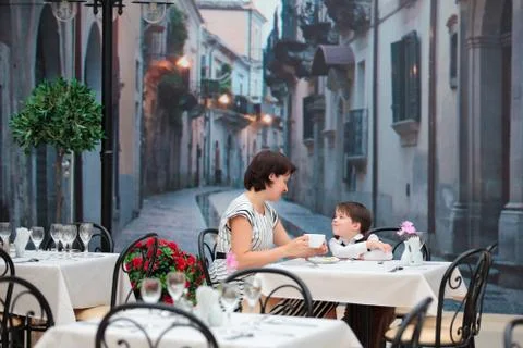 Mother and son sitting in cafe Stock Photos