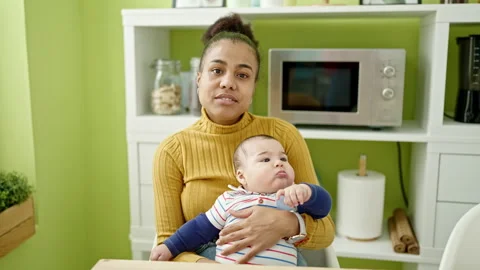 Mother and son sitting on table together at dinning room Video stock 245089747