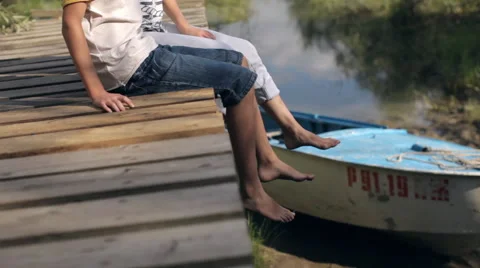 Mother and Son Sitting on a Wooden Pier Stock Footage