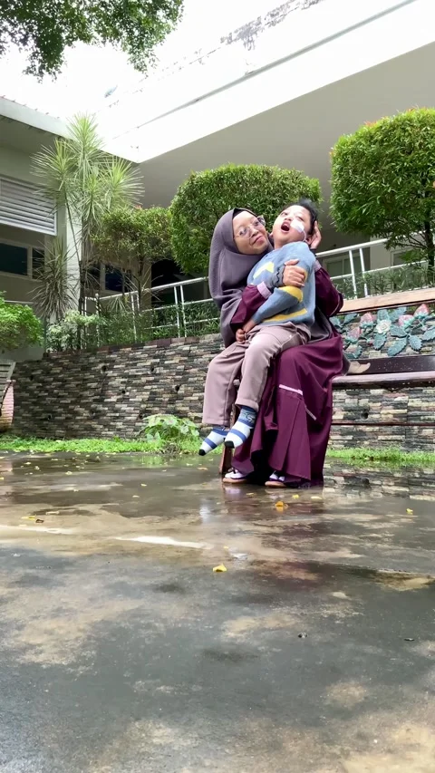Mother and Son with Special Needs on Park Bench Stock Footage 328634622