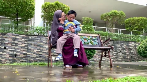 Mother and Son with Special Needs on Park Bench Stock Footage 328634690