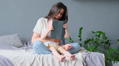 Mother and son with tablet at home. Mother showing media content on line to her Stock Footage 158181545