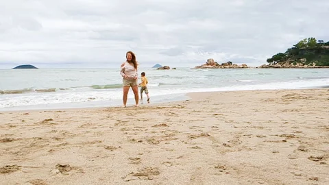 Mother and son take fun on beach. Video stock 266255284