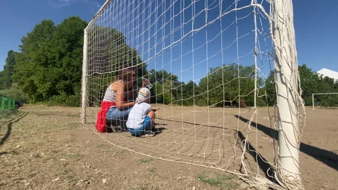 Mother and Son Take Refreshing Water Break at Sunny Playground Stock Footage 322121494