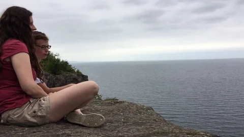 Mother and Son Talking at Edge of Cliff 스톡 동영상 79113227