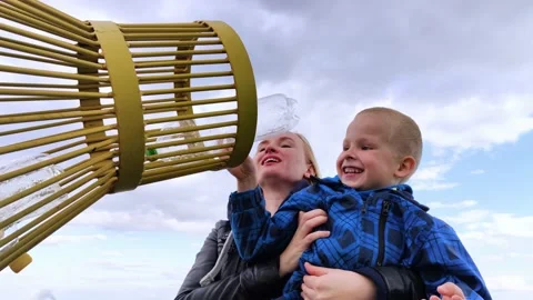 Mother and son throw the plastic bottle into the plastic collection container. R Stock Footage 153525701