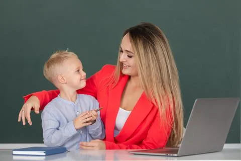 Mother and son together using computer laptop. School child learning education 스톡 사진