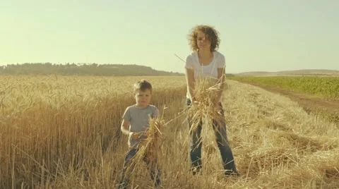 Mother And Son Trowing Ears Of Wheat Stock Footage 63472385