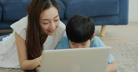 Mother and son using computer together at home. Stock Footage 123140951