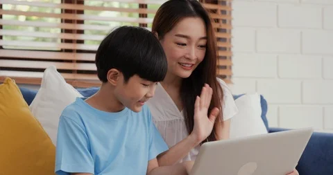Mother and son using computer together at home. Stock Footage 123140976