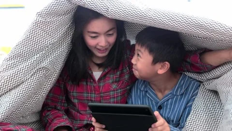 Mother and son is using a digital tablet and smiling happy Stock Footage 144591500