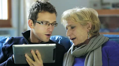 Mother and son using tablet pc at home Stock Footage 34275910