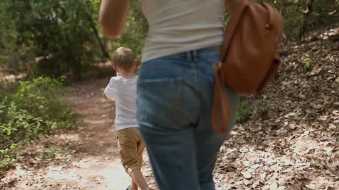 Mother and son walking on a forest path together Stock Footage 322174901