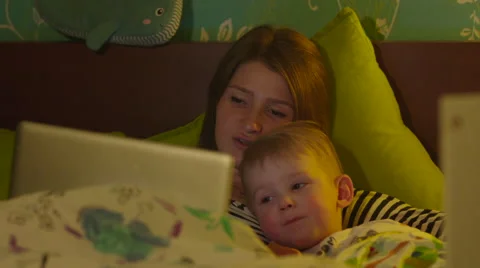 Mother and Son Watching Bedtime Cartoon in Laptop or Tablet Stock Footage 56727894