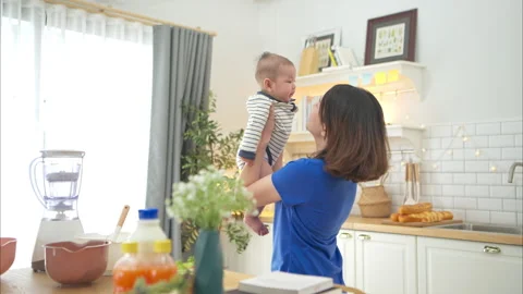 Mother and tiny child in the kitchen preparing dinner 스톡 동영상 288164598