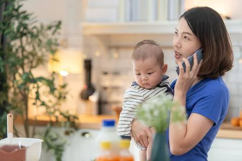 Mother and tiny child in the kitchen preparing dinner Mother and tiny chil... Stock Photos