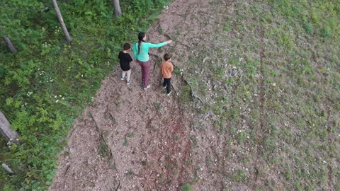 Mother and two children walking on a path through a forest Stock-Footage 314972746