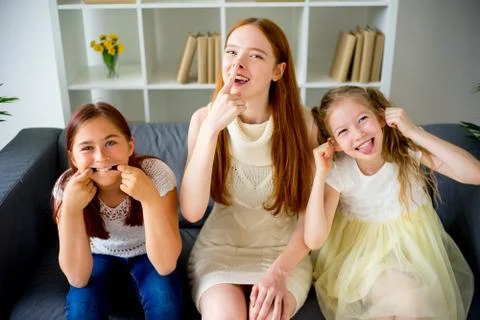 Mother and two daughters making faces Stock Photos