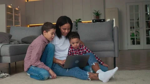 Mother and two sons making a video call with their relatives by laptop Stock Footage 169609495