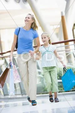 Mother and young daughter at a shopping mall Stock Photos