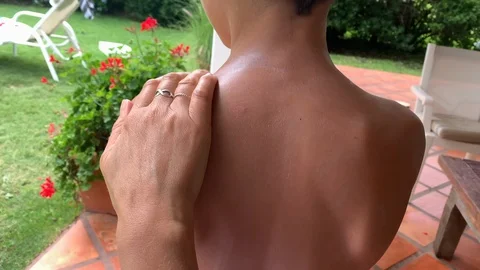 Mother applying sunblock to child back. Parent rubbing sunscreen to kid skin Stock Footage 126936284