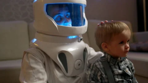 A mother in an astronaut costume pats he... | Stock Video | Pond5