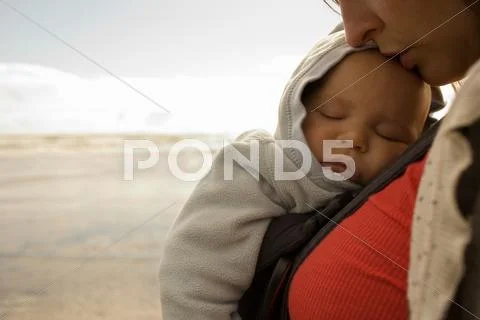 Mother With Baby Boy In Sling