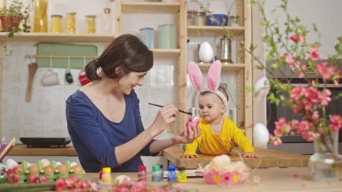 Mother with baby decorating easter eggs. Stock Footage 175861320