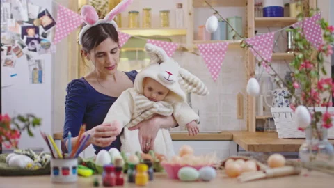 Mother with baby decorating easter eggs. Stock Footage 175874650